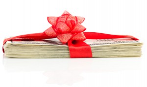 Stack of Cash With Red Bow Isolated on White