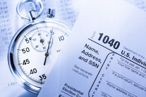 Tax form, operating budget and stopwatch