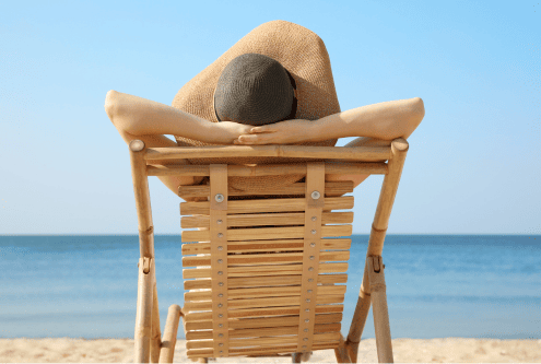 A woman relaxes on the beach after her million dollar divorce