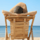 A woman relaxes on the beach after her million dollar divorce